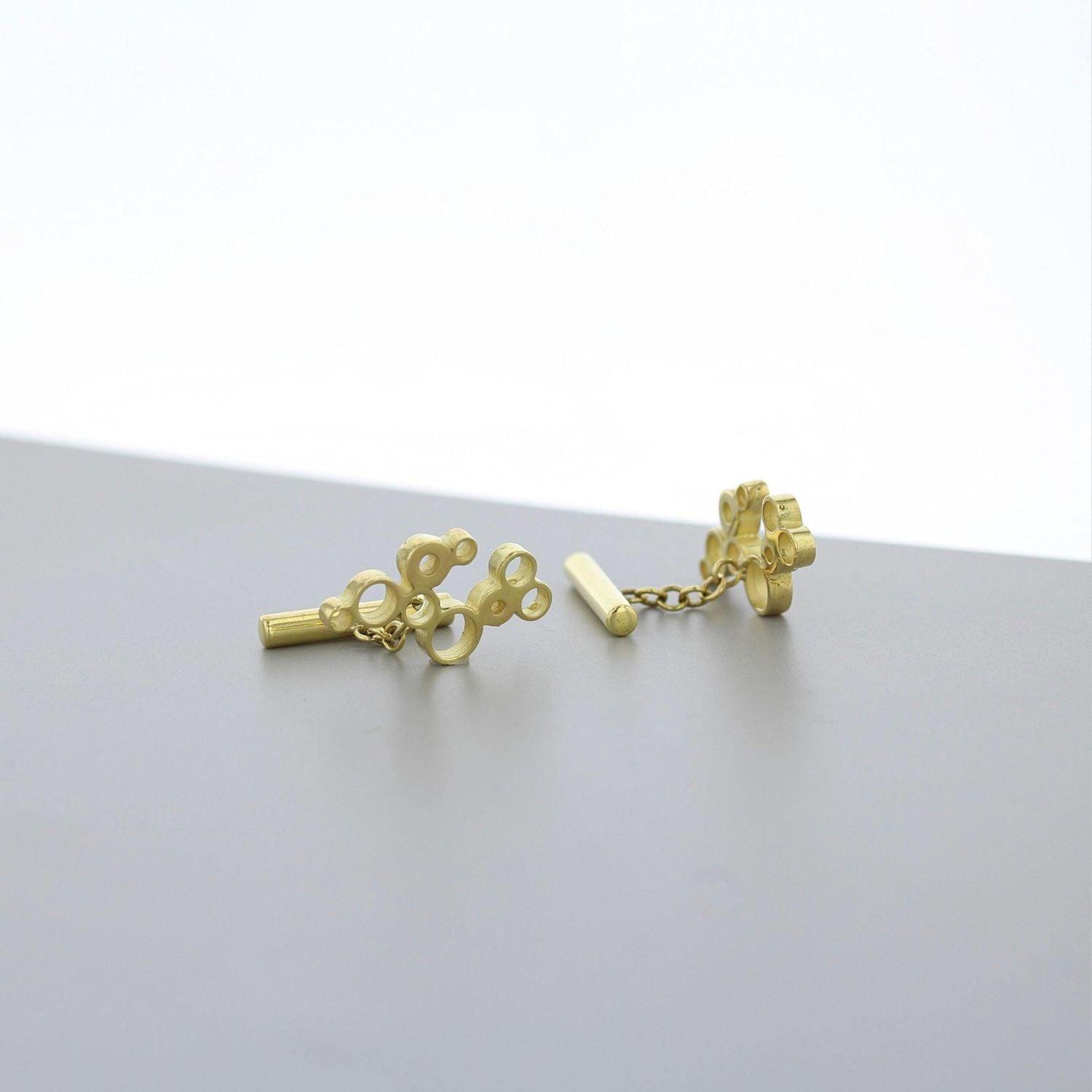 Close detail of the Golden Bubbles cufflink's clustered circles, echoing bubbles in a glass — Botymau Coesau Aur