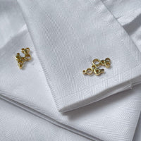 Side view of the Golden Bubbles cufflinks, celebration-themed design — Botymau Coesau Aur
