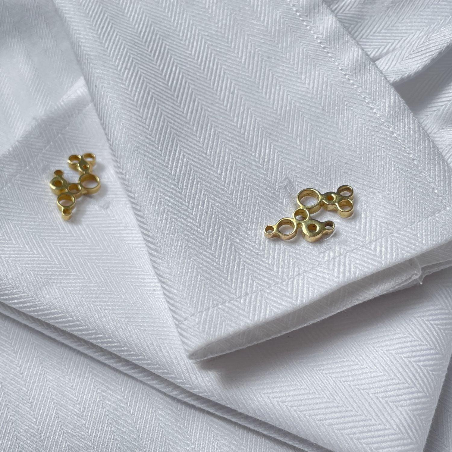 Side view of the Golden Bubbles cufflinks, celebration-themed design — Botymau Coesau Aur