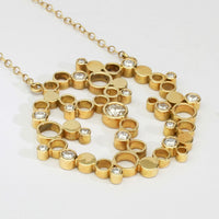 Close-up of the diamonds set into the Golden Bubbles pendant's clustered circles — Mwclis Aur