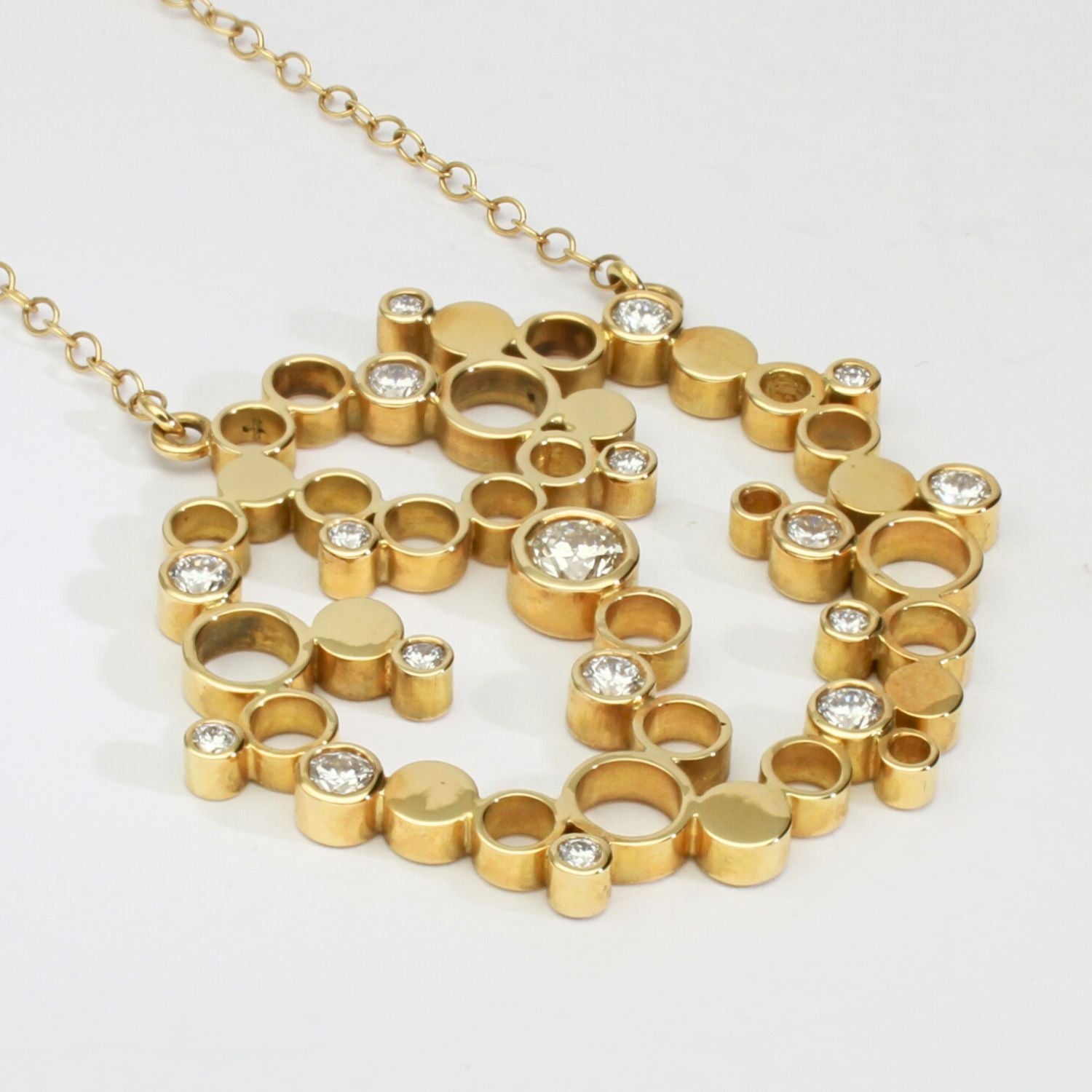 Close-up of the diamonds set into the Golden Bubbles pendant's clustered circles — Mwclis Aur