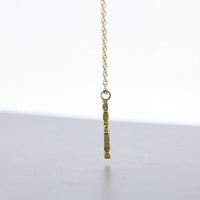 Close-up on the Golden Bubbles pendant's clustered circles, echoing bubbles in a glass — Mwclis Aur