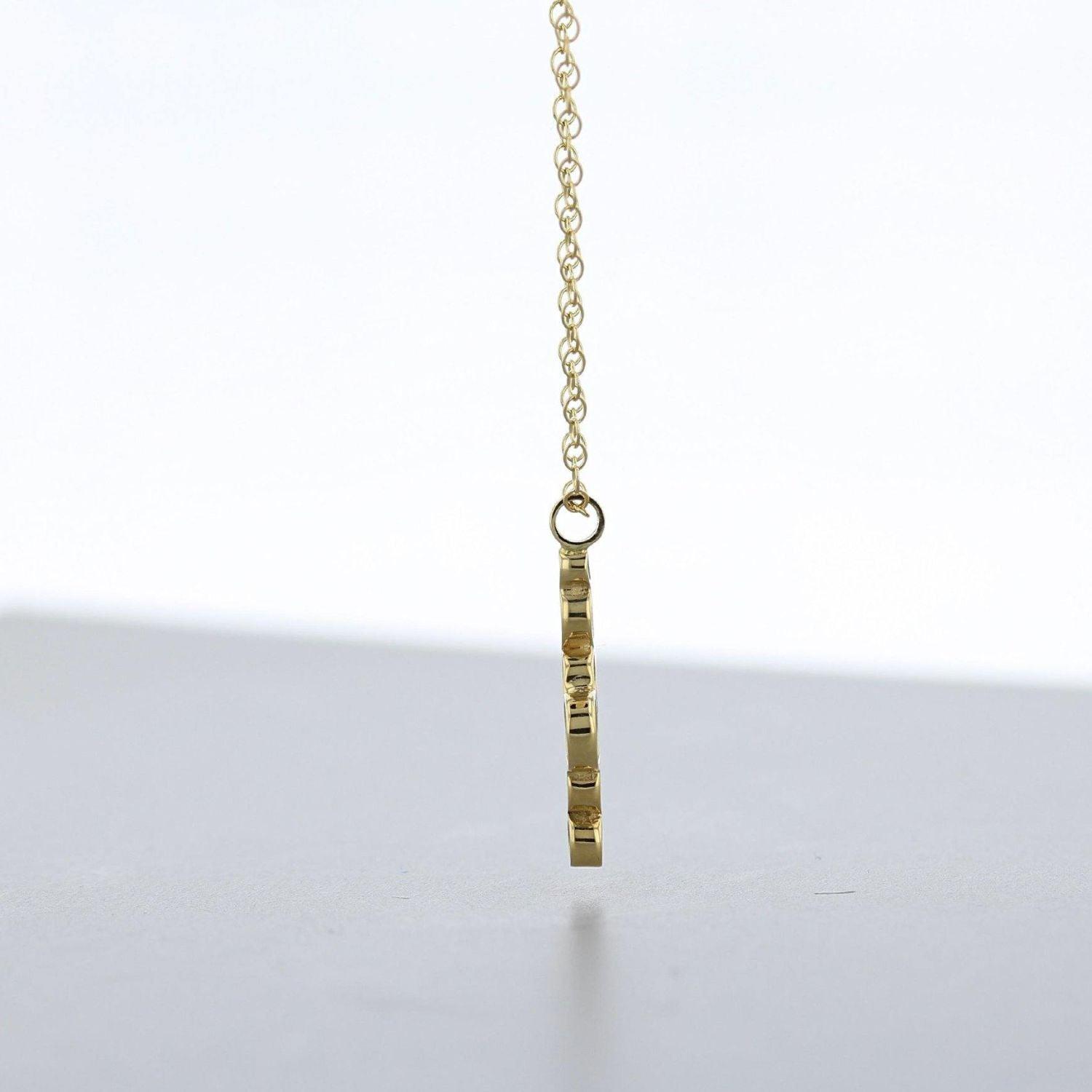 Close-up on the Golden Bubbles pendant's clustered circles, echoing bubbles in a glass — Mwclis Aur