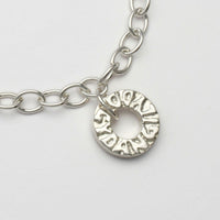 Gyda'n Gilydd bracelet close-up of handwritten charm engraving, sterling silver