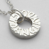 Gyda'n Gilydd sterling silver pendant, close-up of handwritten charm engraving