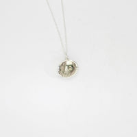 Large cockle silver pendant with a peacock freshwater pearl by Kate Wimbush