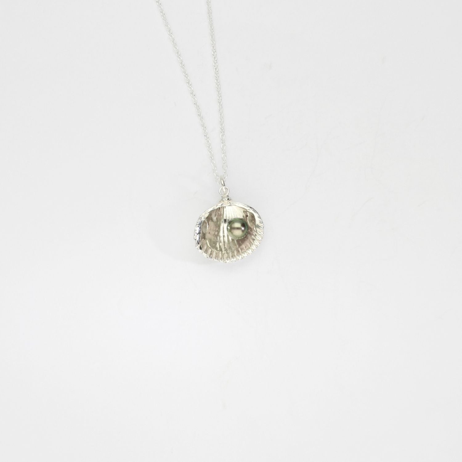 Large cockle silver pendant with a peacock freshwater pearl by Kate Wimbush
