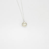 Small silver cockle pendant with cream freshwater pearl by Kate Wimbush