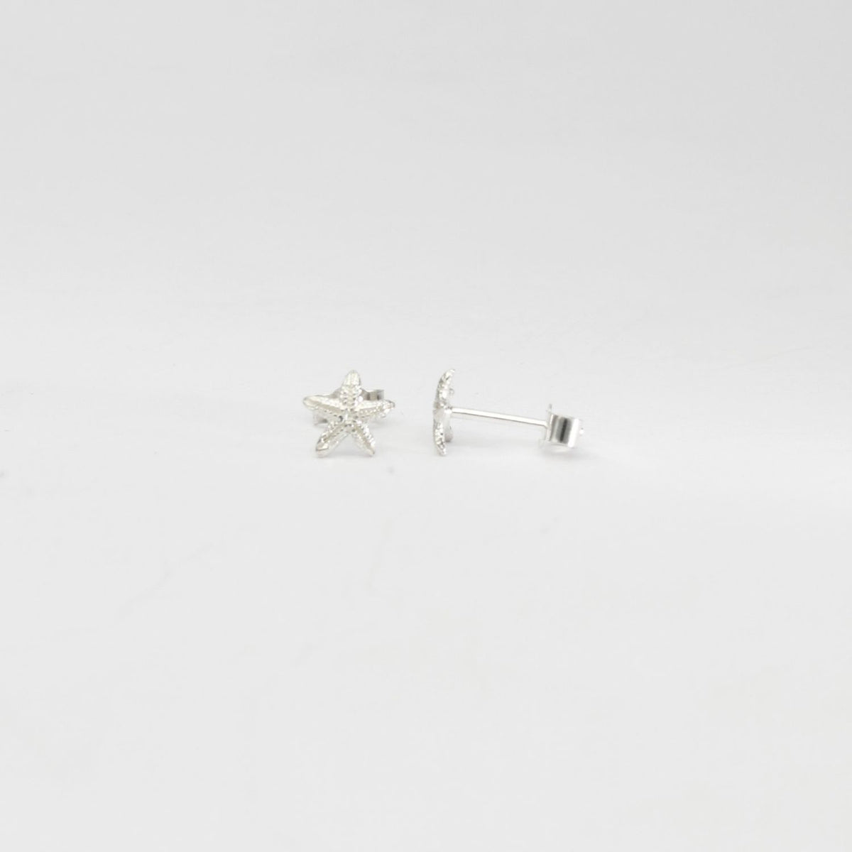 Small starfish silver studs by Kate Wimbush