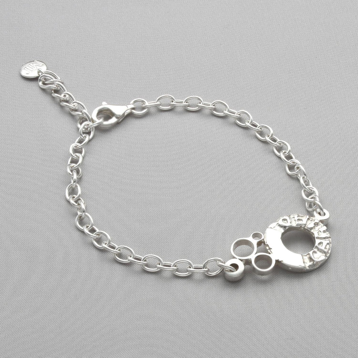 Sterling silver charm bracelet with engraved Welsh word charm, front view
