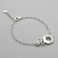 Sterling silver charm bracelet with engraved Welsh word charm, front view